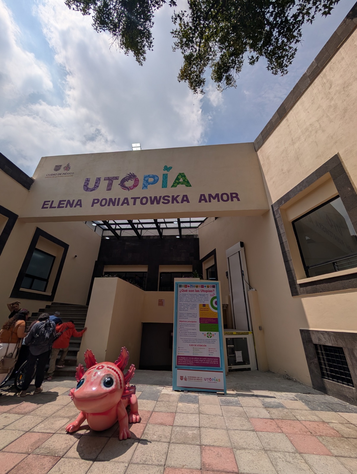 Entrance of the UTOPÍA Elena Poniatowska Amor in Coyoacán, with a pink axolotl welcoming visitors